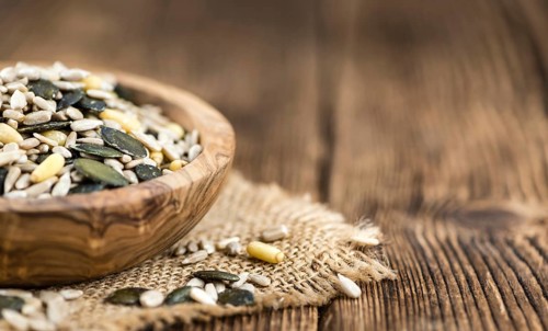 Mixed Seeds (close-up shot, selective focus) on vintage wooden background