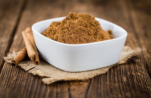 Fresh made Cinnamon Powder on a vintage background (close-up shot)