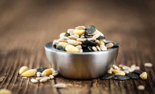 Mixed Seeds (close-up shot, selective focus) on vintage wooden background