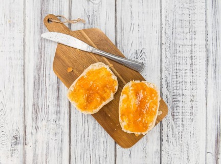 Peach Jam on a vintage background as detailed close-up shot, selective focus