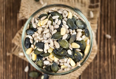 Portion of mixed Seeds (close-up shot, selective focus) on wooden background