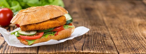 Fresh made Chicken Schnitzel on a bun (close-up shot, selective focus)