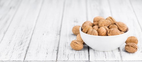Walnuts on a vintage background as detailed close-up shot (selective focus)