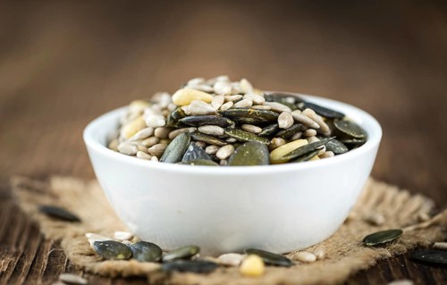 Mixed Seeds (close-up shot, selective focus) on vintage wooden background