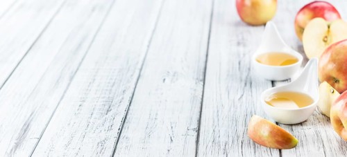 Wooden table with Applesauce (close-up shot, selective focus)