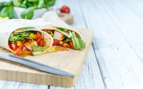 Portion of Chicken Wraps (selective focus) on an old wooden table