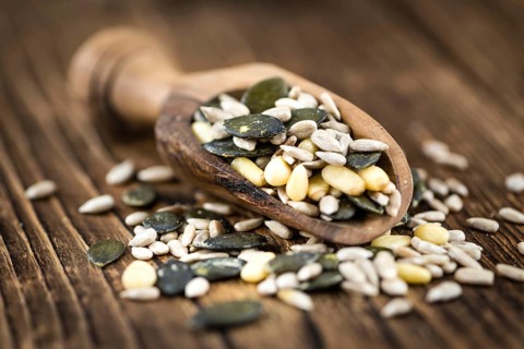Heap of mixed Seeds (close-up shot) on wooden background