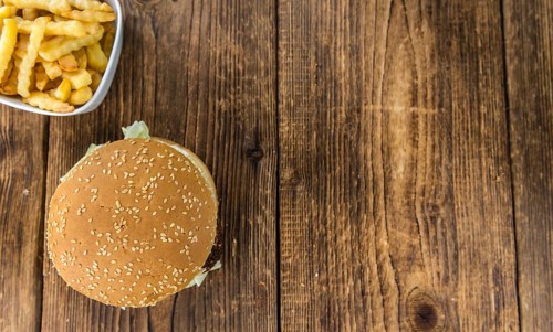 Wooden table with a homemade Falafel Burger (selective focus)