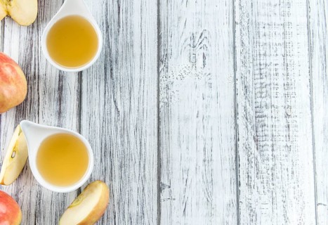 Portion of fresh made Applesauce (close-up shot) on vintage background