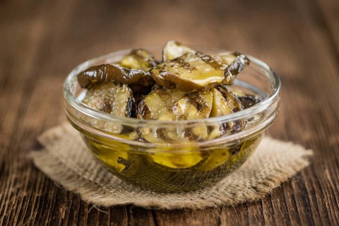 Homemade Antipasti (Grilled Zucchinis) on vintage background (selective focus, close-up shot)