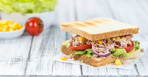 Homemade Tuna Sandwich (selective focus, close-up shot) on vintage wooden background