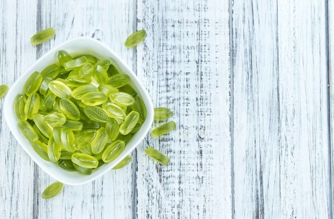 Gummy Candy with lime taste (selective focus) on wooden background