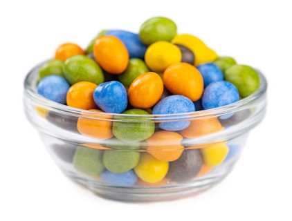 Chocolate coated peanuts isolated on white background (selective focus)