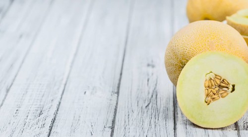 Fresh made Honeydew Melon on a vintage background (close-up shot)