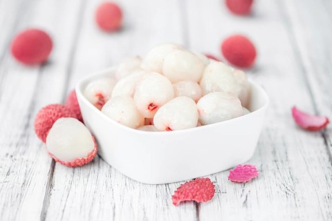 Lychees on a vintage background as detailed close-up shot (selective focus)