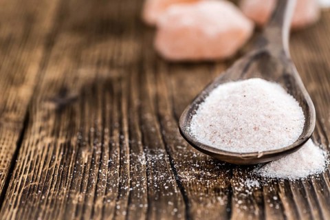 Pink Himalayan Salt on an old wooden table as detailed close-up shot (selective focus)