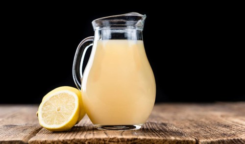 Lemon Juice on a vintage background as detailed close-up shot (selective focus)