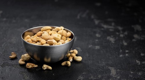 Some roasted Cashew Nuts as detailed close up shot (selective focus)