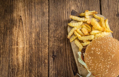 Wooden table with a homemade Falafel Burger (selective focus)