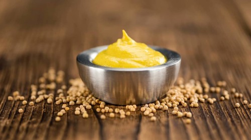Mustard on a vintage background as detailed close-up shot (selective focus)