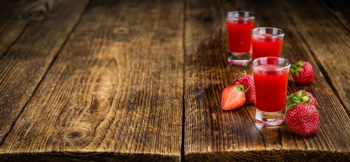 Homemade Strawberry liqueur on vintage background selective focus, close-up shot