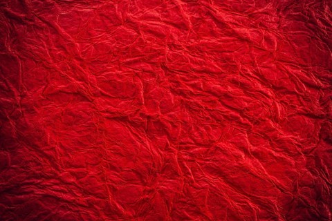 Background surface of wrinkled red and crumpled paper