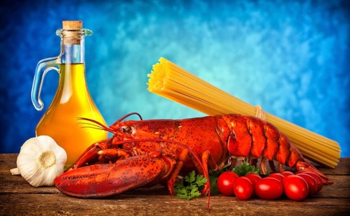 Ingredients of lobster with linguine on wooden table
