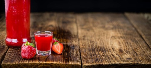 Some homemade Strawberry liqueur as detailed close-up shot, selective focus