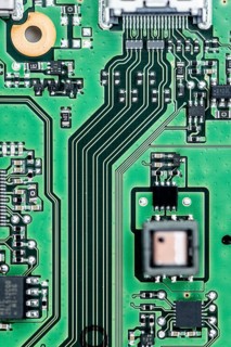 Green PCB (printed circuit board) close-up shot with a lot of electronic components