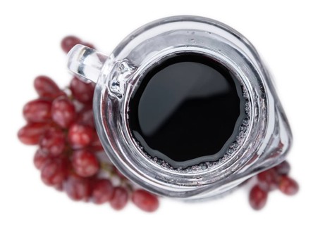 Red Grape Juice isolated on white background (selective focus, close-up shot)