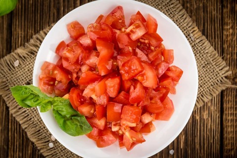 Homemade Cutted Tomatoes on vintage background (selective focus, close-up shot)
