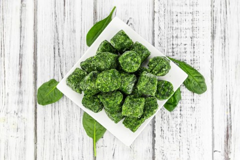 Frozen spinach cubes as detailed close up shot (selective focus)
