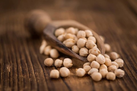 Chickpeas on a vintage background as detailed close-up shot, selective focus