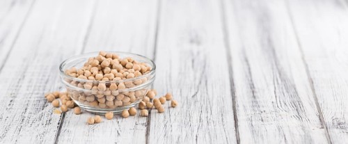 Chickpeas on an old wooden table as detailed close-up shot, selective focus