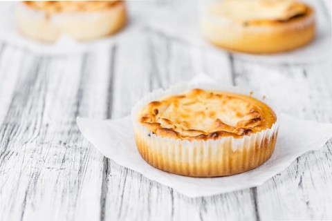 Fresh made Mini Cheesecake on a vintage background (close-up shot)