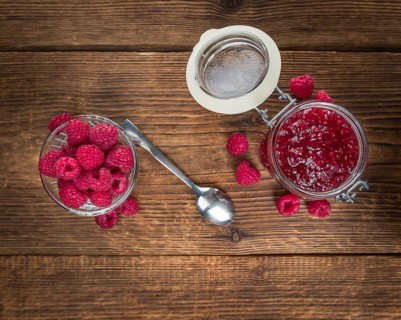 Fresh made Raspberry Jam on a vintage background as detailed close-up shot