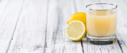 Lemon Juice on a vintage background as detailed close-up shot (selective focus)