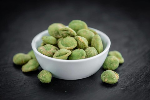 Some fresh Wasabi Peanuts on a vintage slate slab (selective focus, close-up shot)