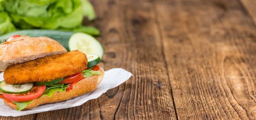 Fresh made Chicken Schnitzel on a bun (close-up shot, selective focus)