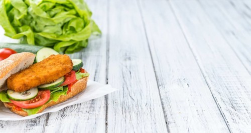 Chicken Schnitzel on a bun (selective focus, detailed close-up shot)