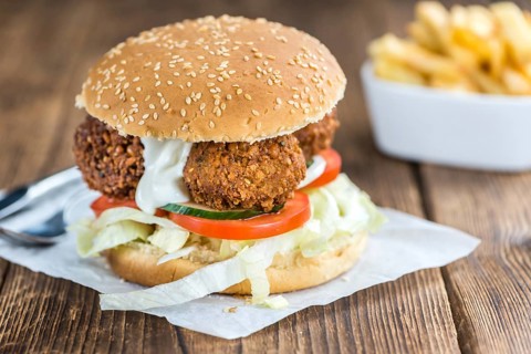 Wooden table with a homemade Falafel Burger (selective focus)