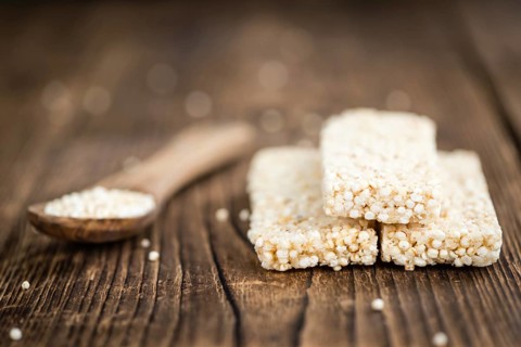 Fresh made Quinoa Bars (selective focus, close-up shot) on an old wooden table