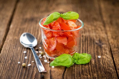 Homemade Cutted Tomatoes on vintage background (selective focus, close-up shot)