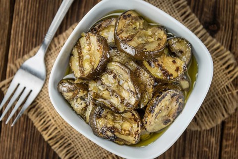 Fresh made Zucchinis (grilled) on an old and rustic wooden table (selective focus, close-up shot)