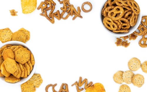 Portion of mixed Snacks isolated on white background (close up shot, selective focus)