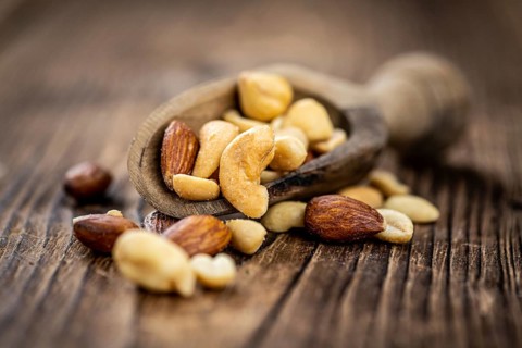 Roasted and salted nuts as detailed close up shot (selective focus)