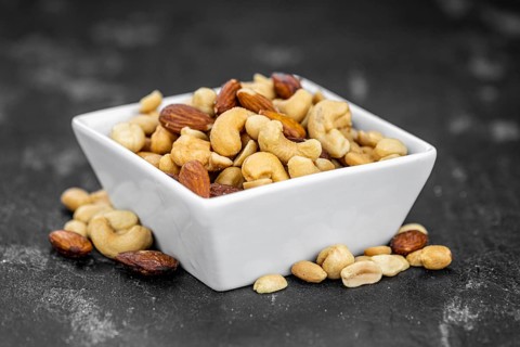 Roasted and salted nuts as detailed close up shot (selective focus)
