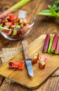 Chopped Rhubarb on an old wooden table (close up shot, selective focus)