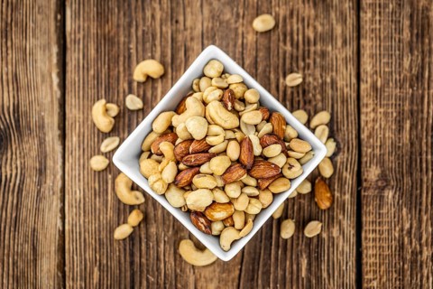 Roasted and salted nuts as detailed close up shot (selective focus)