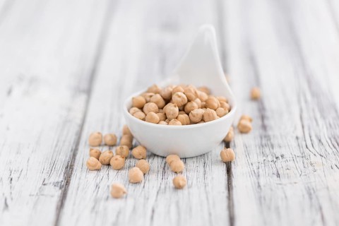 Chickpeas on a vintage background as detailed close-up shot, selective focus